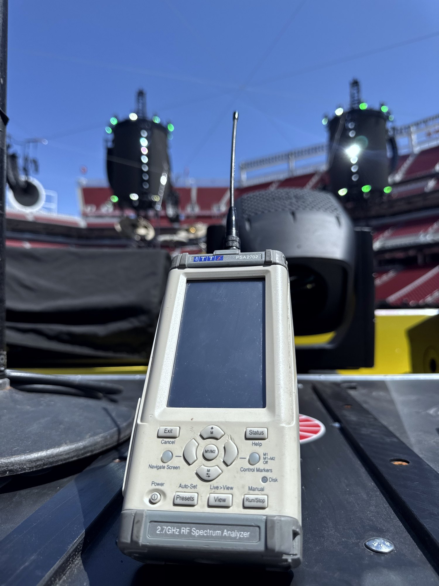 Spectrum analyzer on stage with audio line arrays — large-scale venue RF coordination